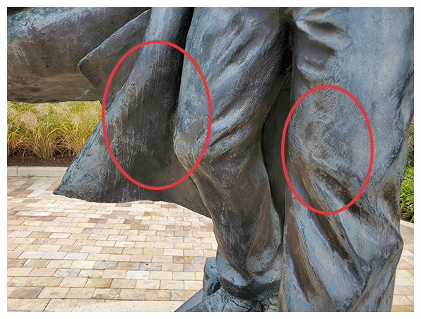 Photograph of discoloration on knees of Frederick Douglass Statue.