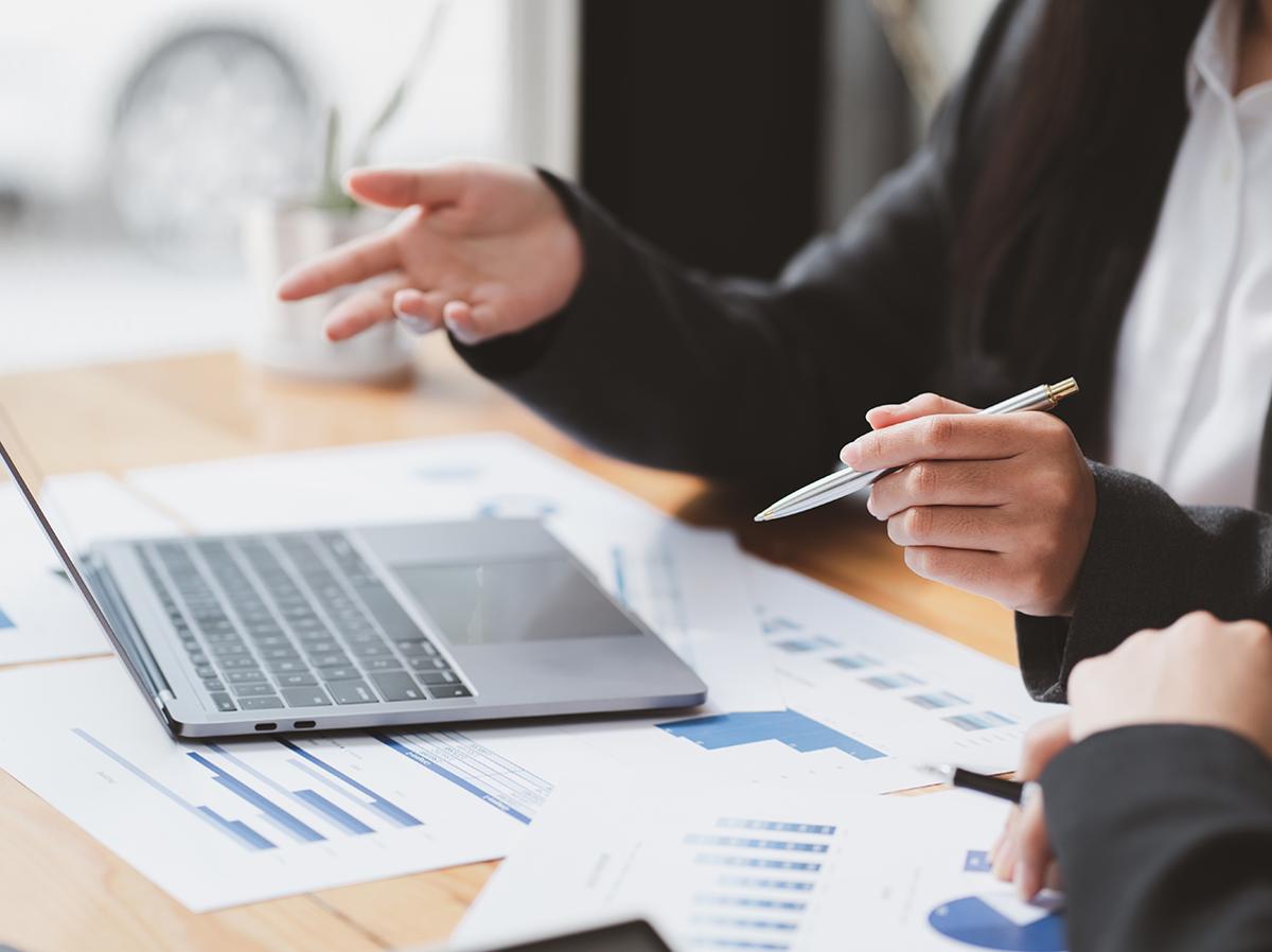 two people at table with laptop