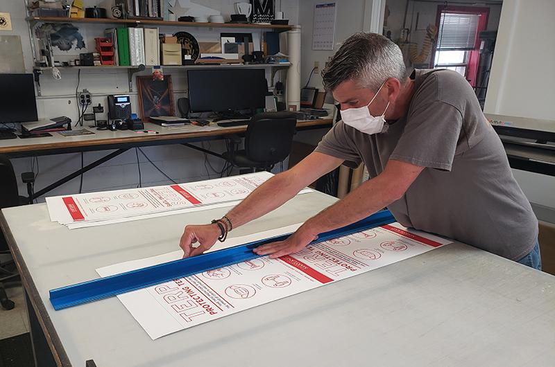 Photograph of employee making sign