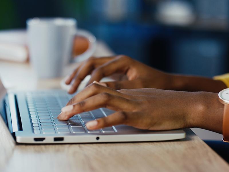 Hands Entering Data on laptop keyboard